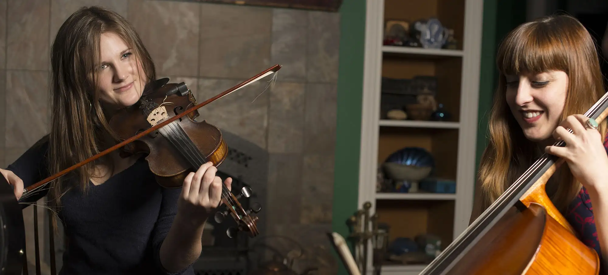 Cayley playing the fiddle with Clea on the cello